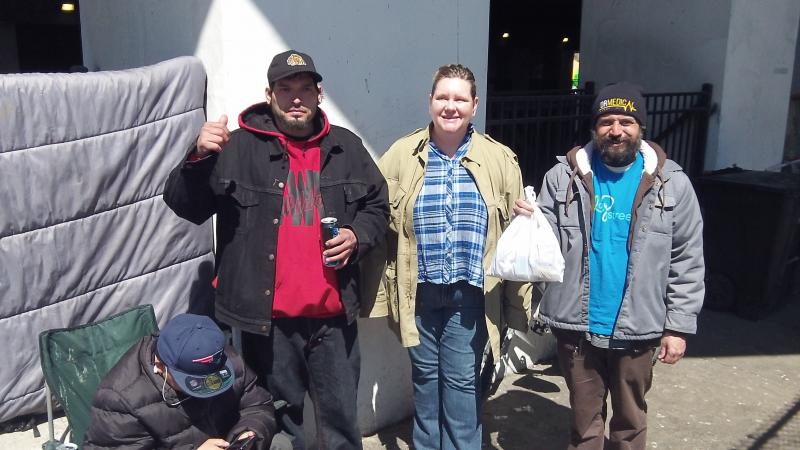 B. Lattanzi GCA rep helps 3 homeless men near a viaduct in Chicago L.